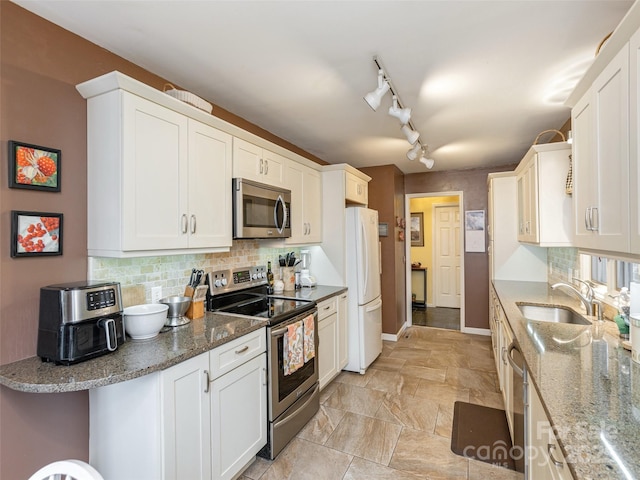 kitchen featuring stainless steel appliances, sink, and white cabinets