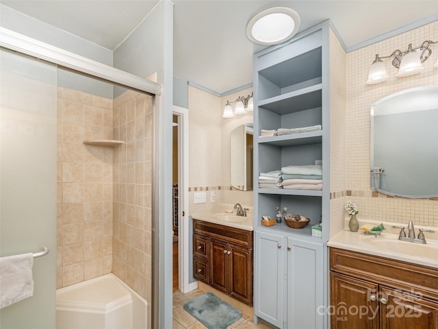 bathroom featuring tile patterned floors, tiled shower, vanity, and decorative backsplash