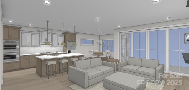 living area featuring light wood-style flooring and recessed lighting