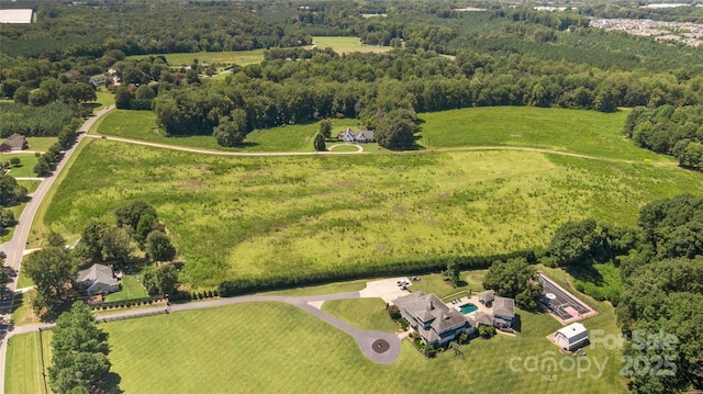 aerial view featuring a wooded view