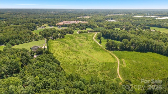 aerial view featuring a wooded view