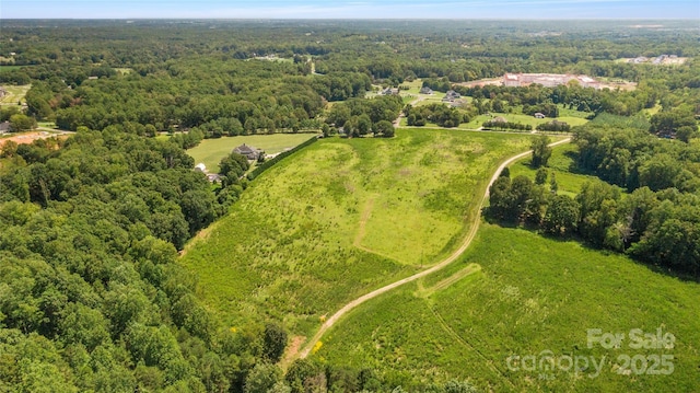 birds eye view of property with a forest view