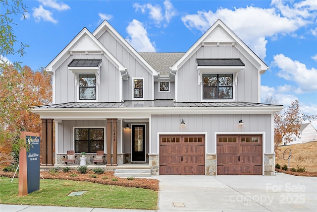 modern farmhouse featuring a garage and a porch