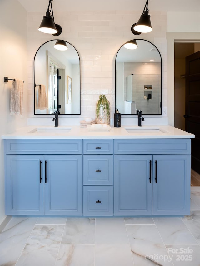 bathroom with vanity, decorative backsplash, and walk in shower