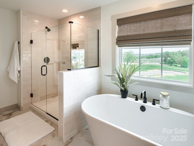 bathroom featuring separate shower and tub