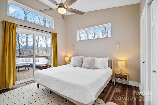 bedroom with multiple windows, ceiling fan, and dark hardwood / wood-style flooring