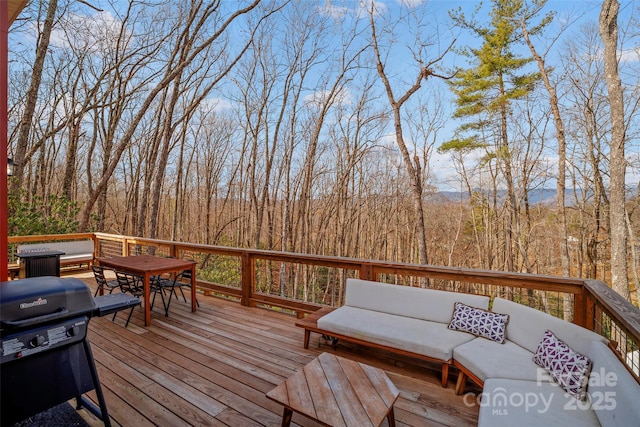 wooden deck with a grill and an outdoor living space