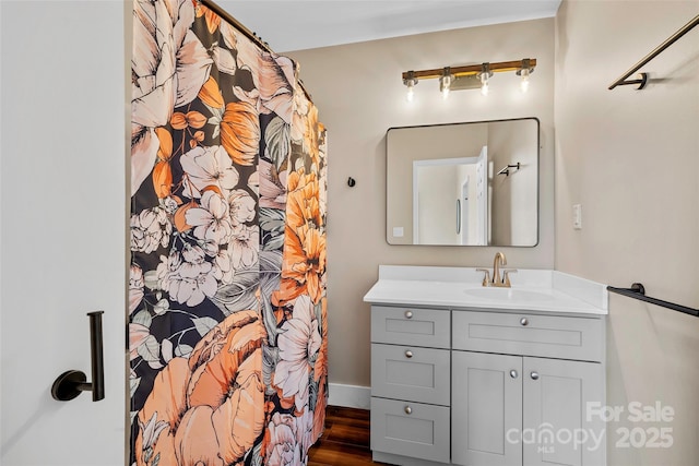 bathroom with vanity and hardwood / wood-style flooring