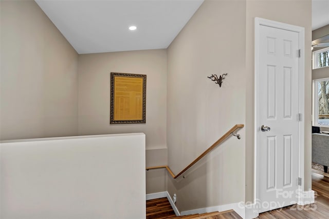 stairs featuring wood-type flooring