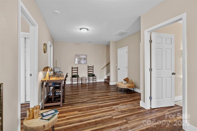 corridor with hardwood / wood-style floors