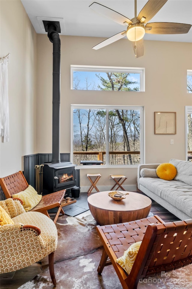 186 S Slope Ln, Old Fort, NC 28762 - living room with plenty of natural light, a high ceiling, a wood stove, and ceiling fan