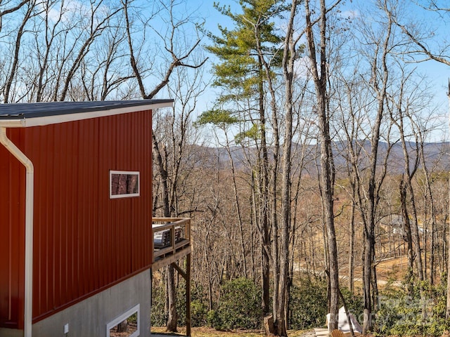 exterior space with an outdoor structure and a forest view