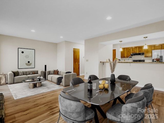 dining area featuring light wood-type flooring