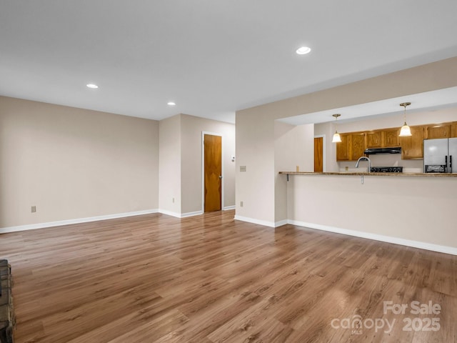 unfurnished living room featuring hardwood / wood-style floors