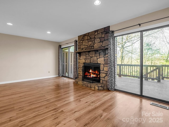 unfurnished living room with hardwood / wood-style flooring and a fireplace