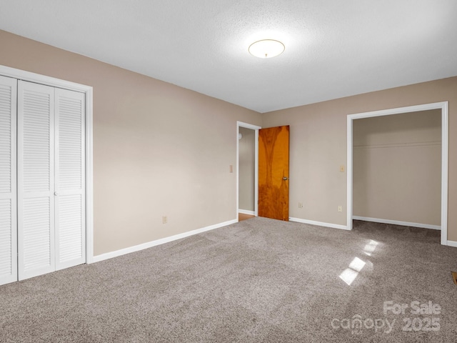 unfurnished bedroom with carpet floors, a closet, and a textured ceiling