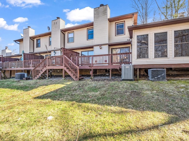 back of property featuring cooling unit, a yard, and a wooden deck