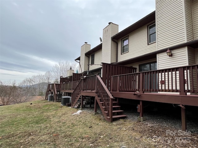 back of house with a yard, central AC, and a deck