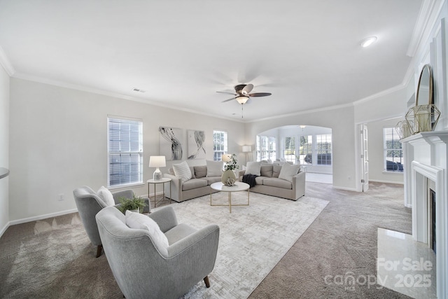 living room with crown molding, ceiling fan, and carpet floors