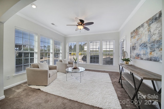 living room featuring crown molding, ceiling fan, and dark carpet