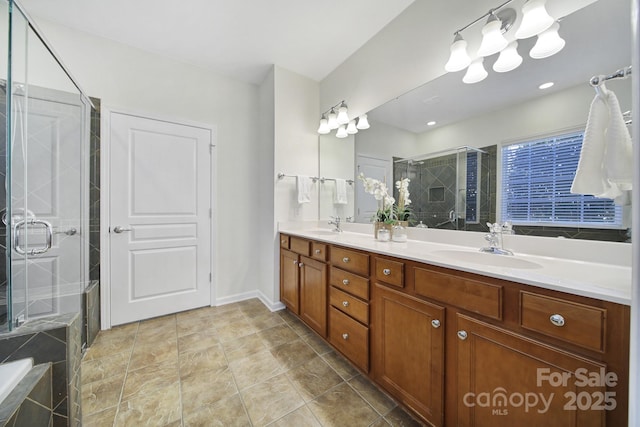 bathroom with tile patterned floors, vanity, and a shower with shower door