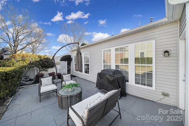 view of patio with area for grilling and an outdoor living space