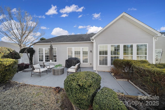 rear view of property featuring a patio area