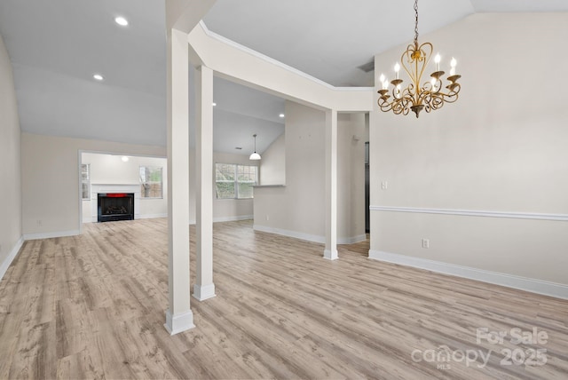 unfurnished living room with vaulted ceiling and light wood-type flooring