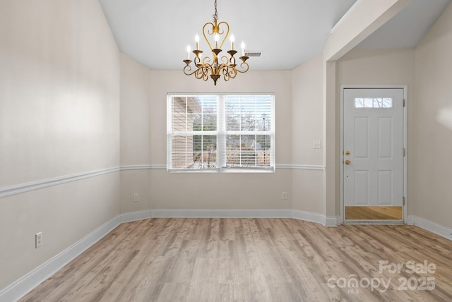 foyer featuring a chandelier and light wood-type flooring