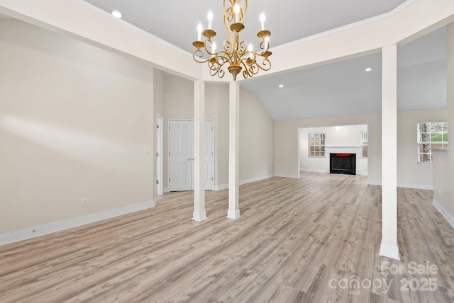 unfurnished living room with lofted ceiling, light hardwood / wood-style flooring, and ornamental molding