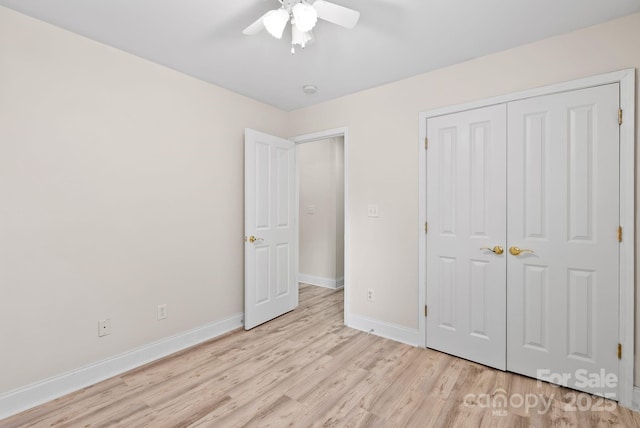 unfurnished bedroom featuring ceiling fan, light hardwood / wood-style floors, and a closet