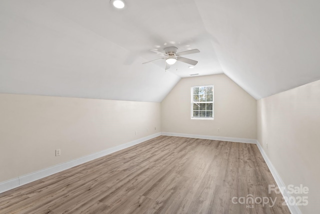 additional living space featuring light hardwood / wood-style flooring, ceiling fan, and vaulted ceiling