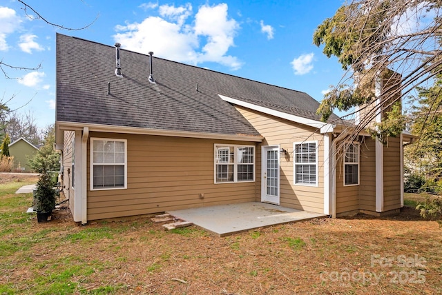 rear view of house featuring a patio and a lawn