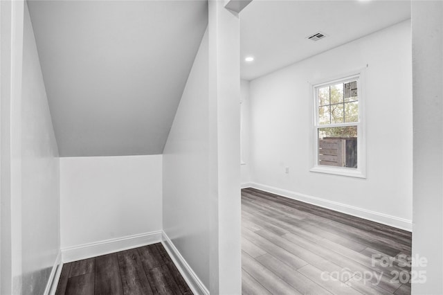 bonus room with visible vents, vaulted ceiling, baseboards, and wood finished floors