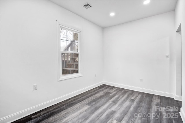 spare room featuring recessed lighting, visible vents, dark wood finished floors, and baseboards