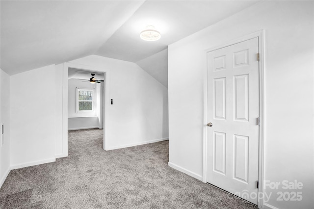 additional living space with vaulted ceiling, carpet flooring, and baseboards