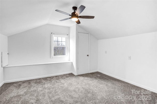 bonus room with lofted ceiling, carpet flooring, ceiling fan, and baseboards