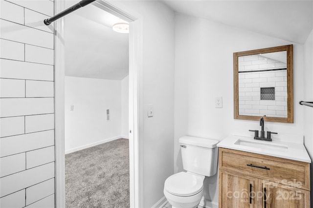 full bath with toilet, vaulted ceiling, vanity, baseboards, and walk in shower