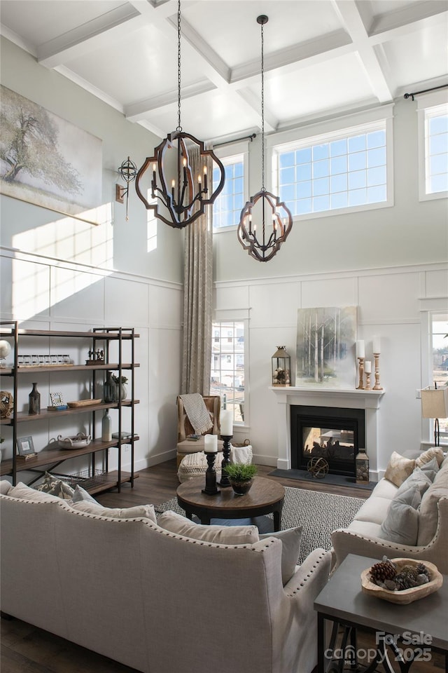 living room featuring beamed ceiling, a multi sided fireplace, coffered ceiling, and dark hardwood / wood-style flooring