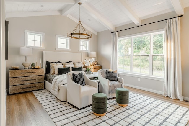 bedroom featuring vaulted ceiling with beams, an inviting chandelier, and light wood-type flooring