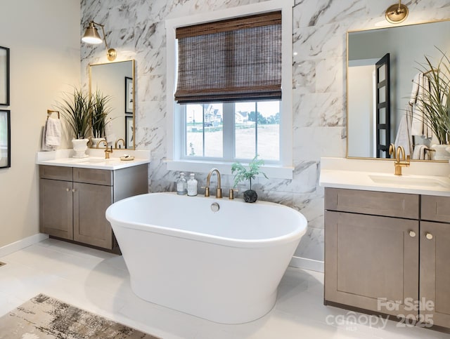 bathroom featuring tile patterned flooring, vanity, a washtub, and tile walls