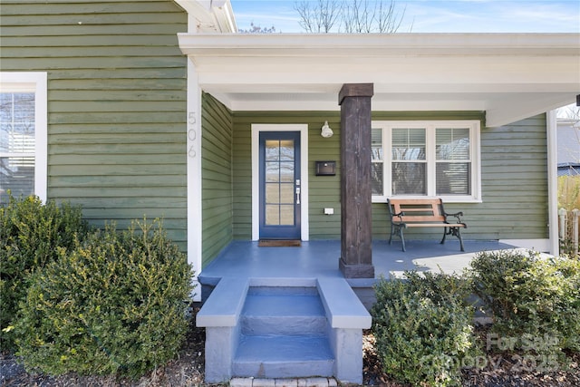 doorway to property featuring covered porch