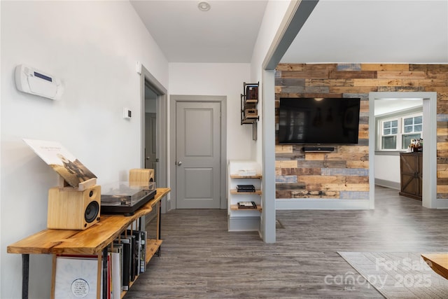 hall featuring dark hardwood / wood-style floors and wood walls