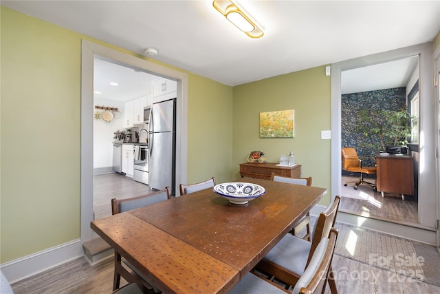 dining space featuring wood-type flooring