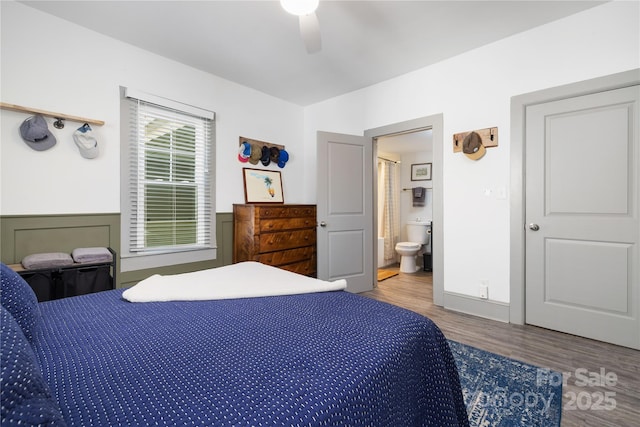 bedroom with ceiling fan, ensuite bathroom, and hardwood / wood-style floors