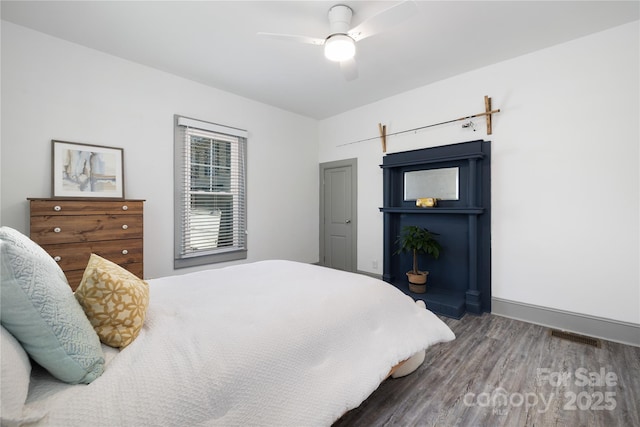 bedroom featuring dark hardwood / wood-style flooring and ceiling fan