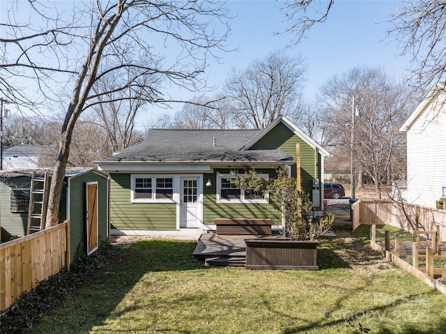 rear view of house featuring a yard