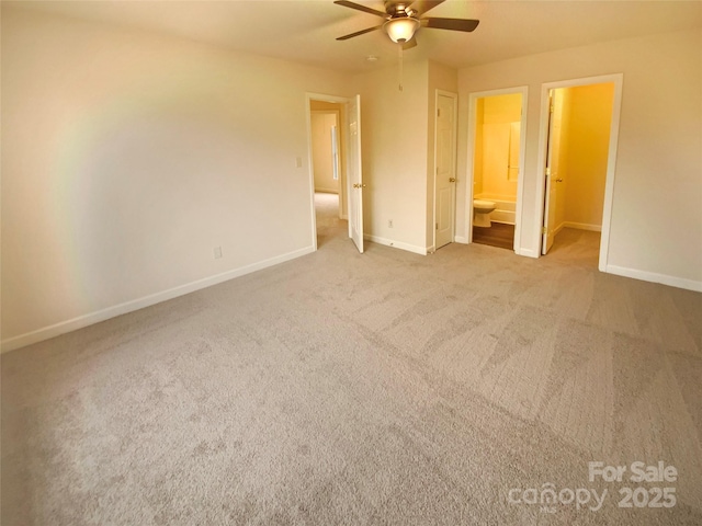 unfurnished bedroom with ceiling fan, connected bathroom, and carpet floors