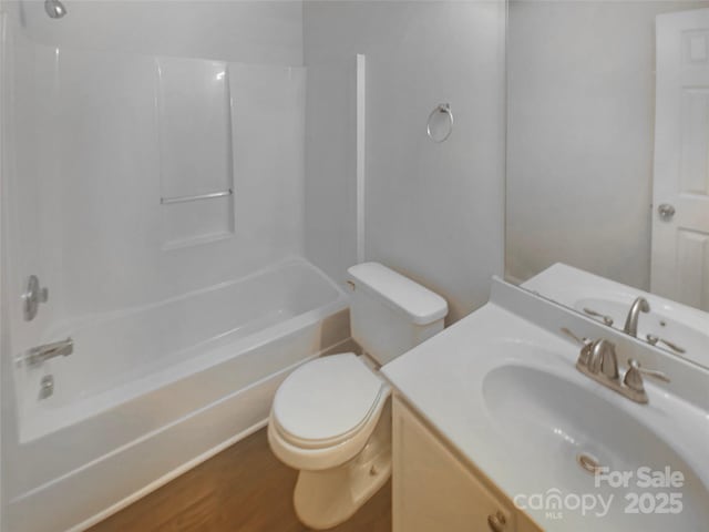 full bathroom with vanity, hardwood / wood-style floors, bathing tub / shower combination, and toilet