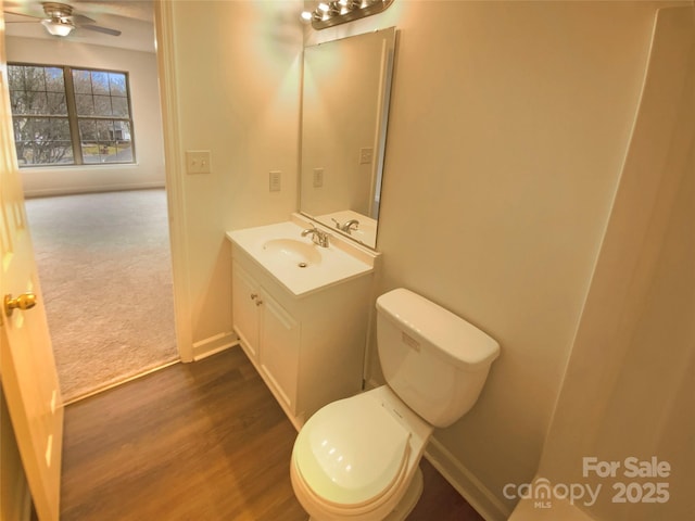 bathroom with vanity, wood-type flooring, ceiling fan, and toilet